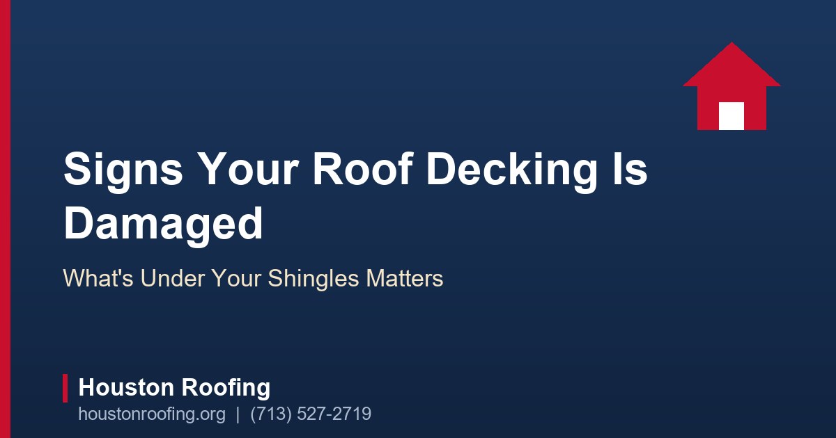 View from inside an attic showing plywood roof decking with dark water staining between rafters