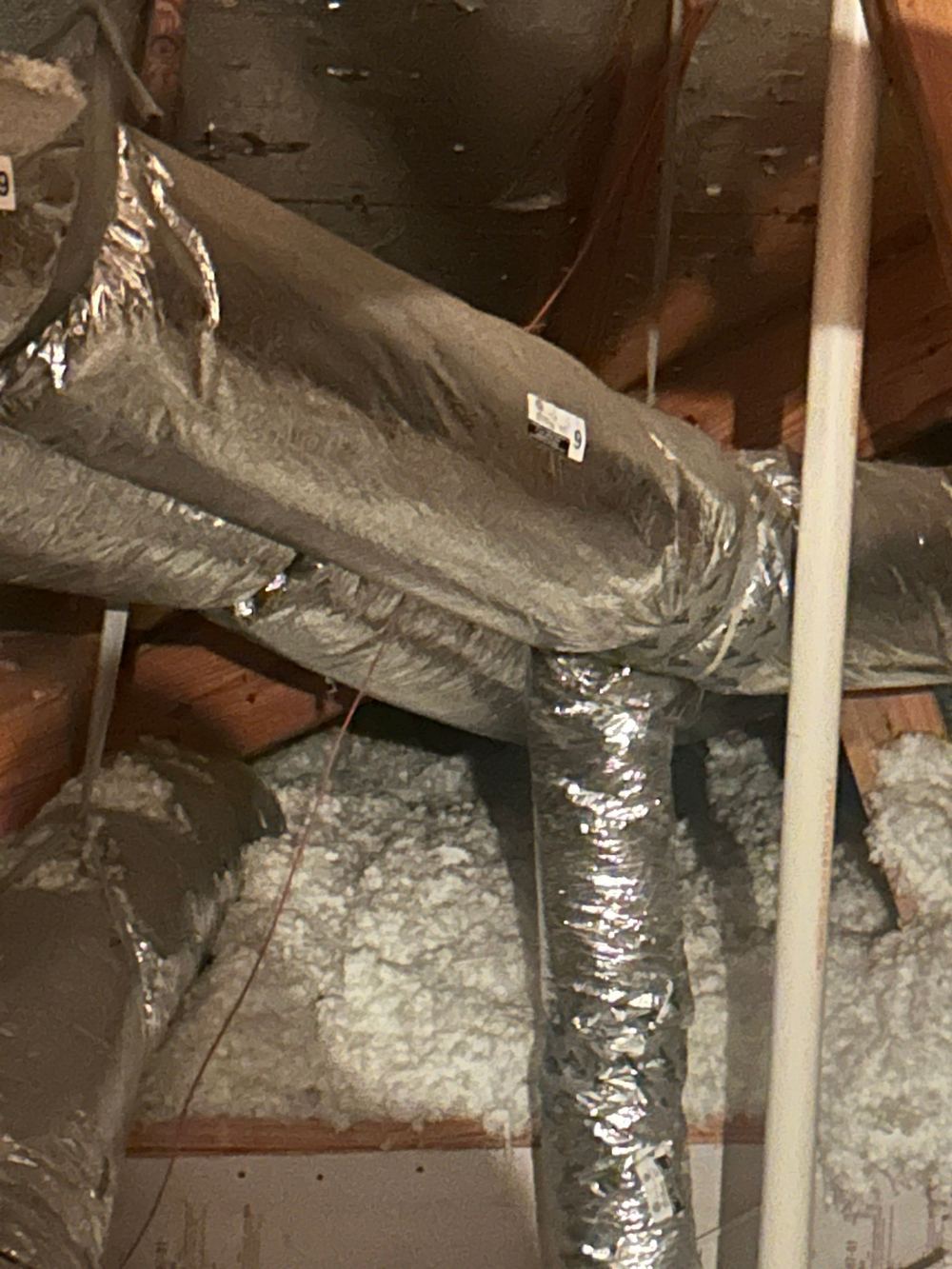 Insulated HVAC ductwork and attic insulation in a Houston area attic