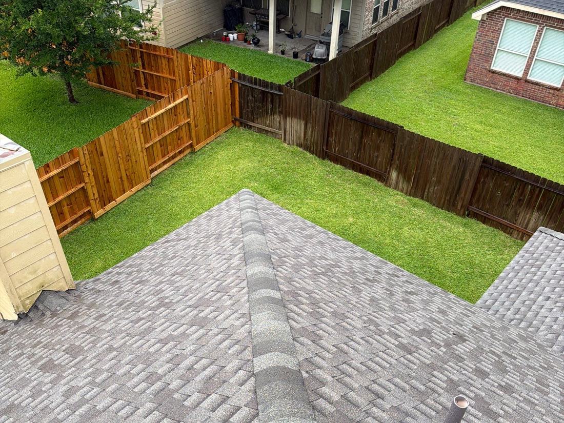 Drone view of a completed architectural shingle roof replacement on a two-story Katy home