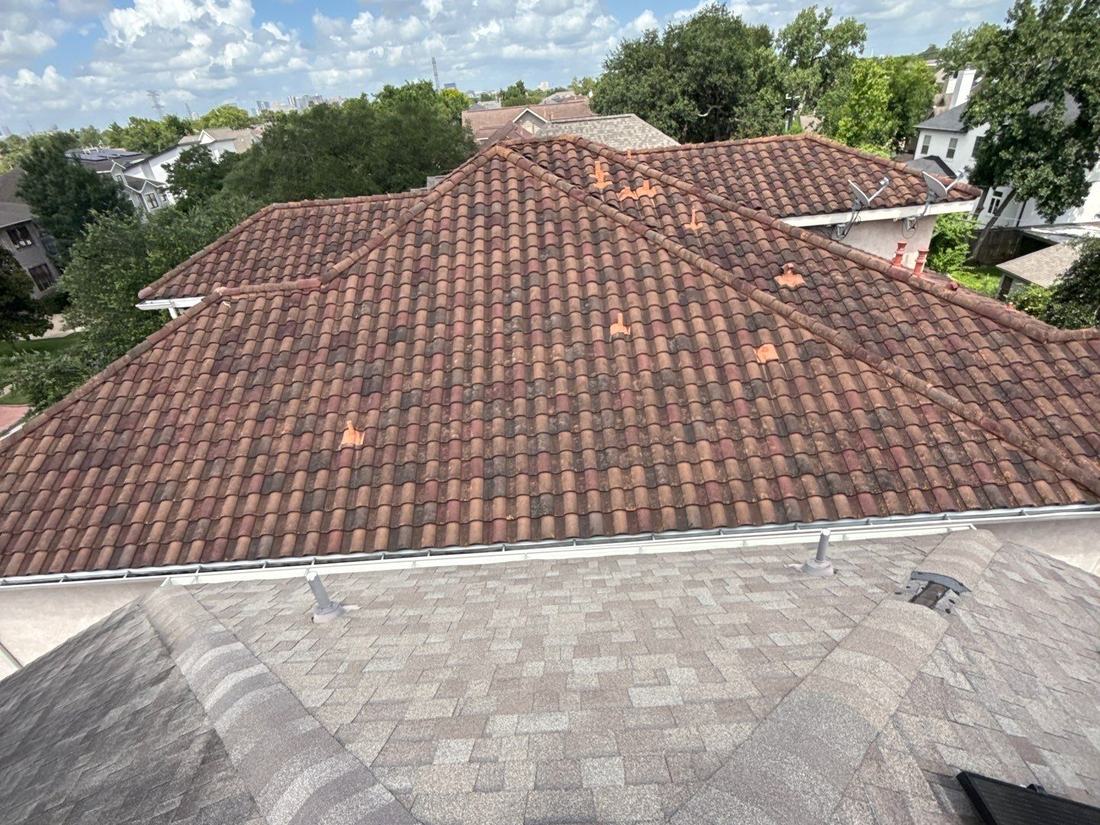 Wide rooftop view from a completed architectural shingle project in Bellaire