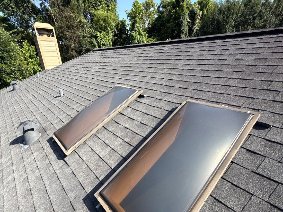 Skylight and flashing detail on an architectural shingle roof at a Katy home